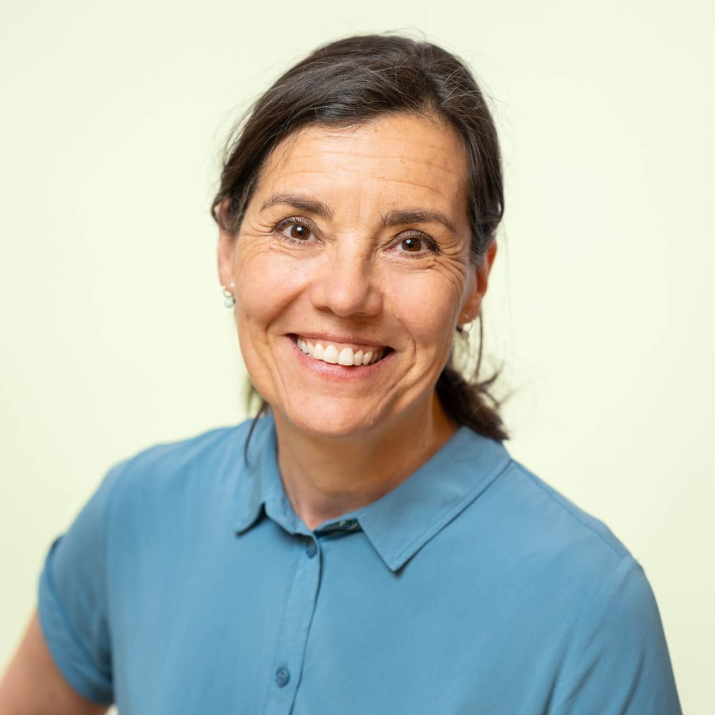 Woman smiles in blue blouse